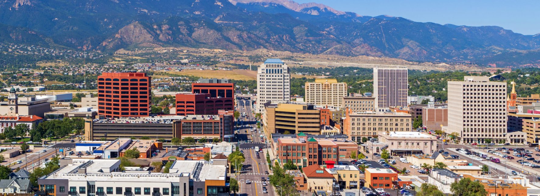 Aerial Of Downtown Colorado Springs With Pikes Peak In The Background